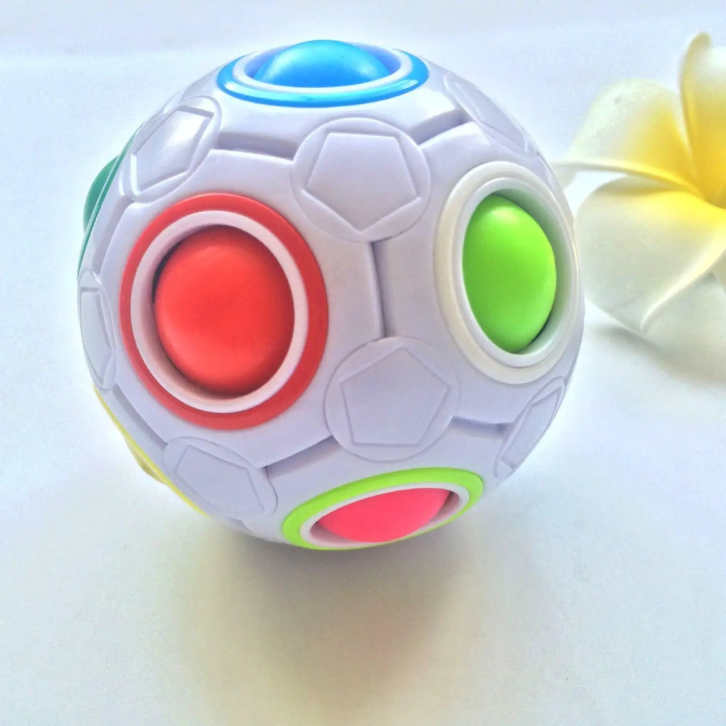 Puzzle Fun Cube Ball white fidget toy with red green blue buttons
