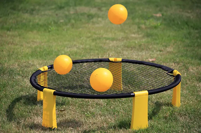 Yellow plastic net with black frame and four legs for beach toss game