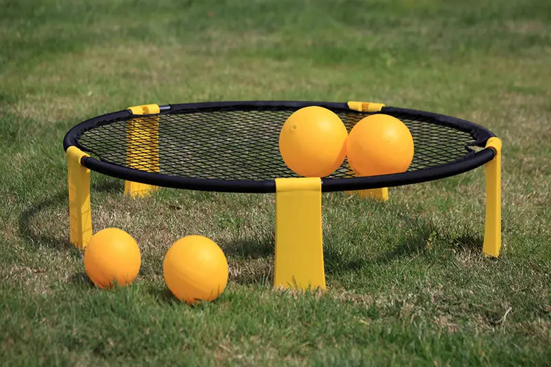 Yellow plastic beach volleyball toss game with black net and 4 balls