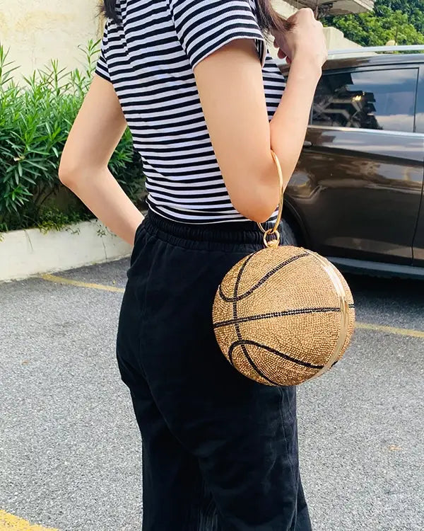 Golden rhinestone basketball clutch bag with black stitches and gold handle