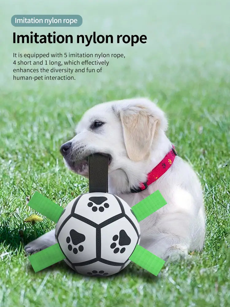 Interactive white dog ball toy with black paw prints and green rope handles
