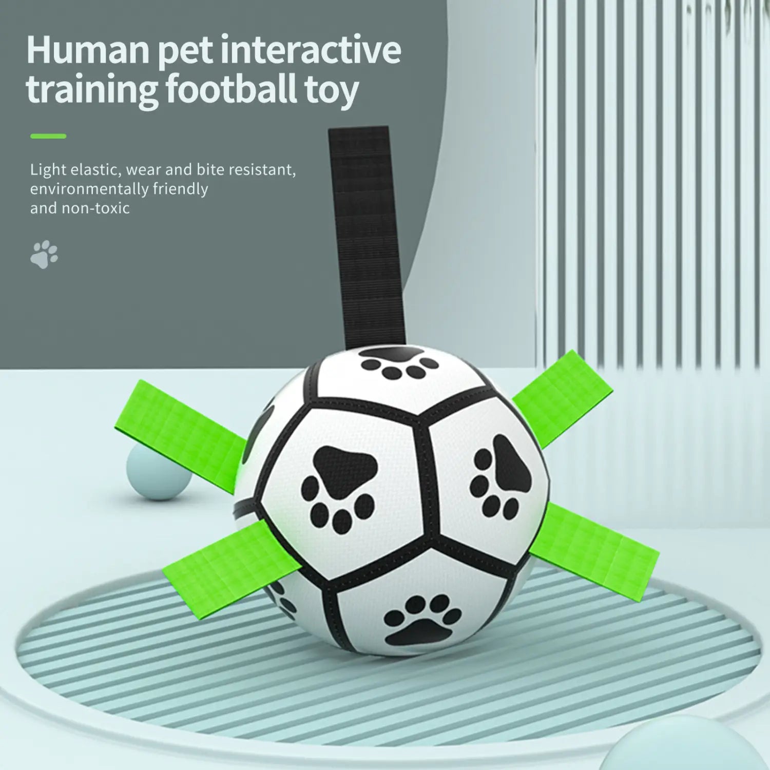 Interactive white black soccer ball dog toy with green elastic strips