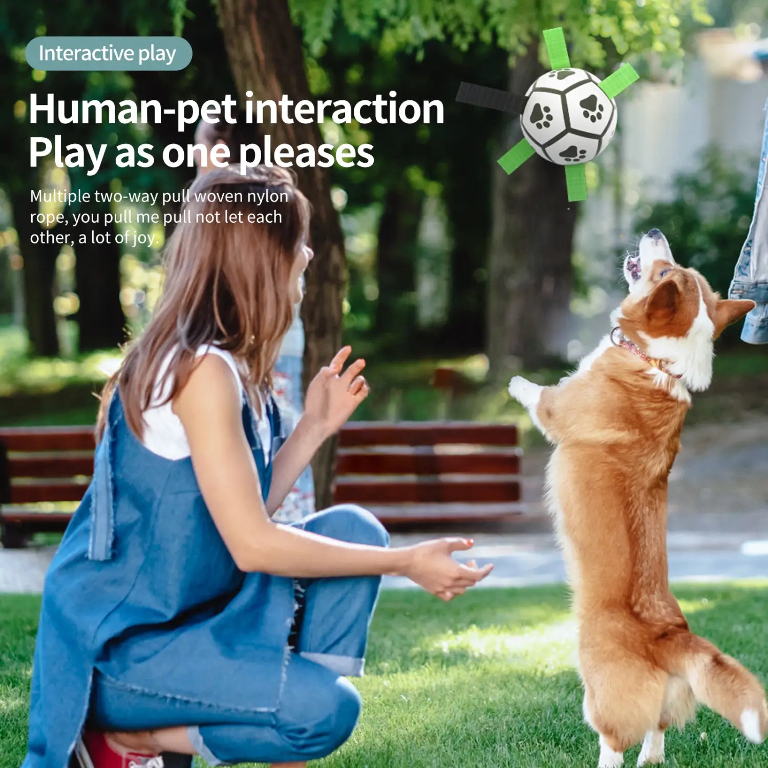 Interactive dog ball with white black paw-print pattern green pull tabs