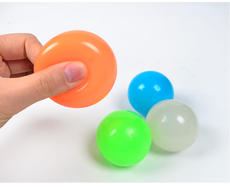 Glow-in-the-dark sticky balls: orange, blue, green, translucent white held in hand