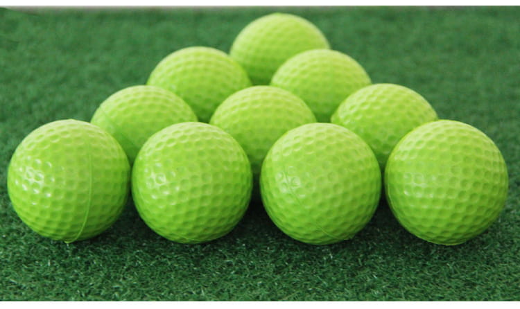 Lightweight foam golf balls in bright lime green with dimpled texture