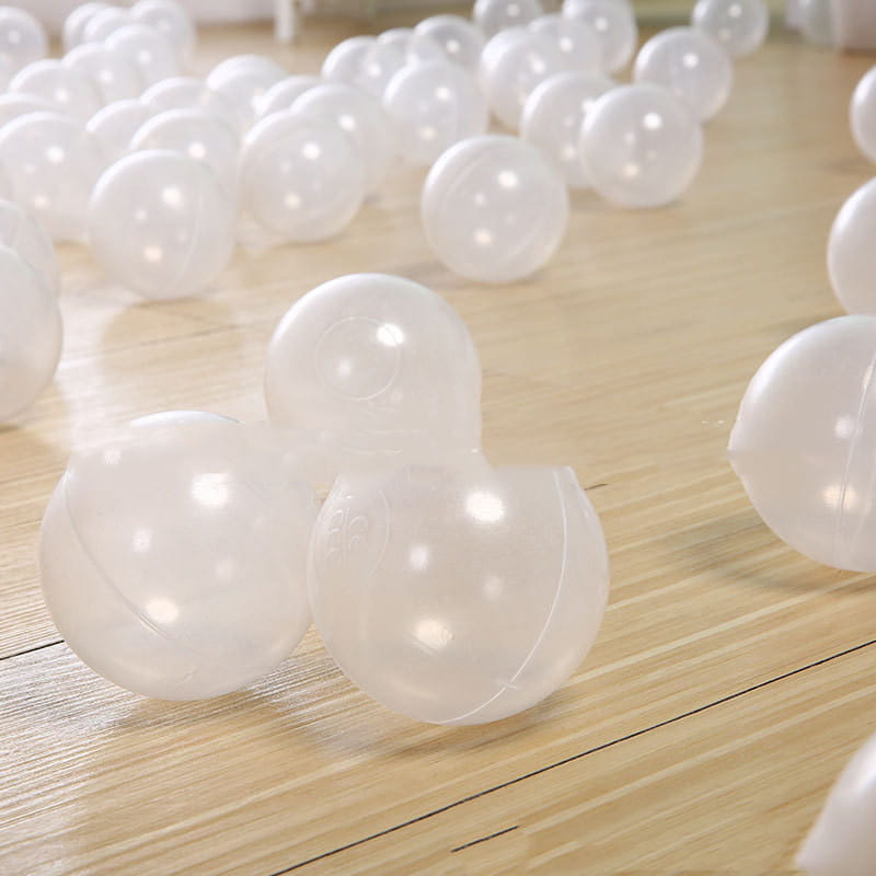 Clear Transparent Crystal Plastic Baby Play Balls scattered on wooden floor