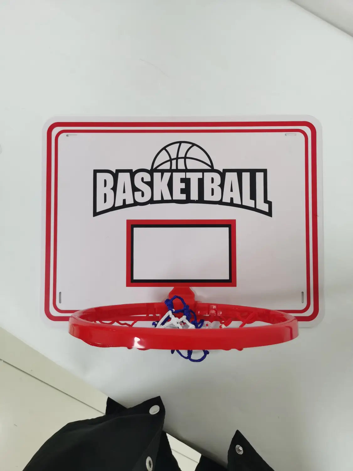 Red plastic basketball hoop with white backboard for kids game set