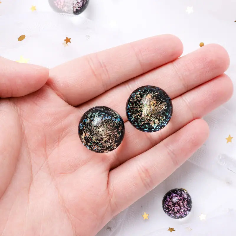 Black resin Cosmic Glass Crystal Ball earrings with gold blue glitter swirls