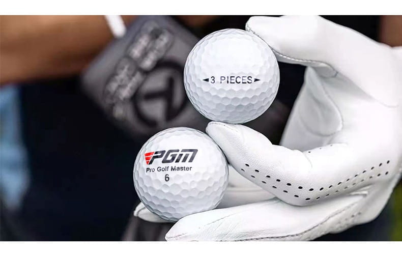 White dimpled golf balls with PGM Pro Golf Master 6 logo and 3 pieces mark