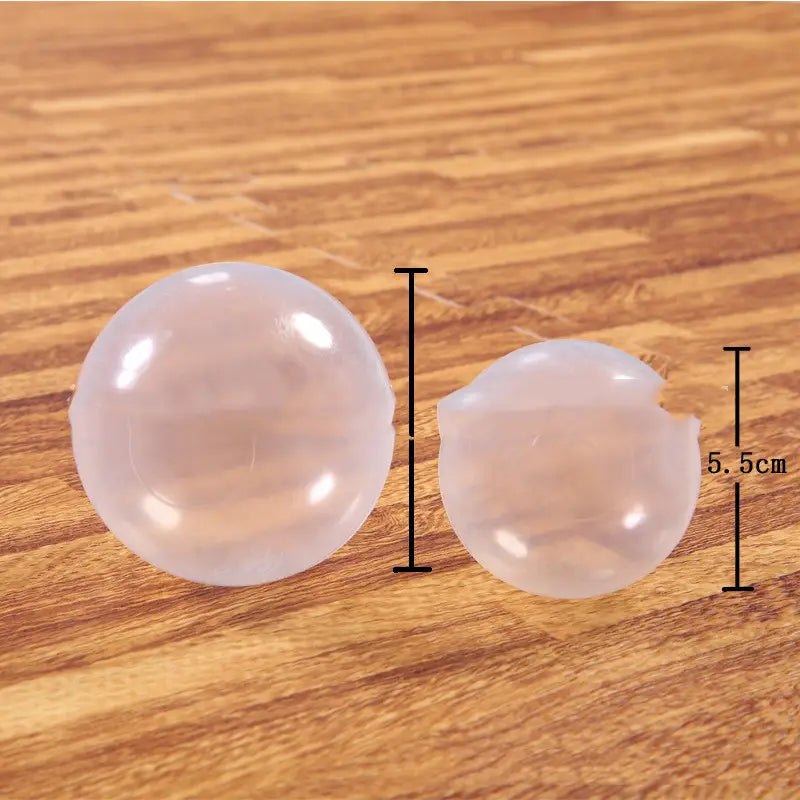 Two translucent frosted plastic corner caps, one intact one bitten, Transparent Crystal Plastic Ball Ocean
