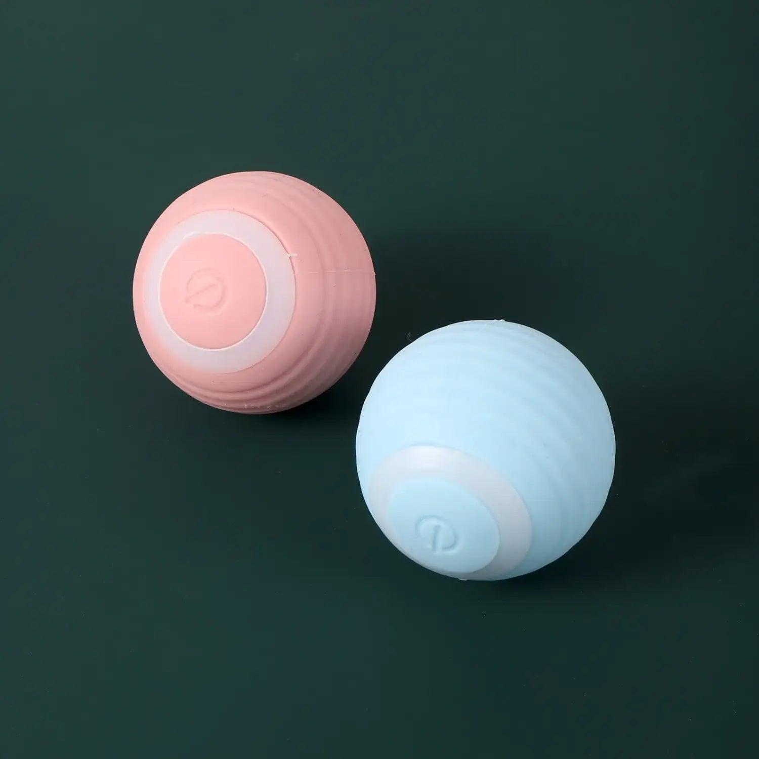 Two pastel silicone massage balls in pink and light blue for Interactive Rechargeable Cat Ball Toy