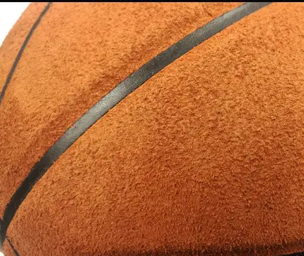 Orange basketball with black seams and cowhide texture for indoor outdoor use