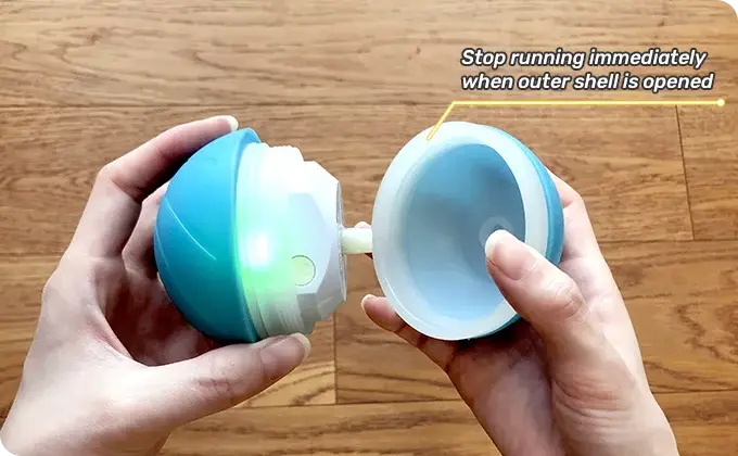 Bouncing Ball teal and white spherical toy with glowing green inner light