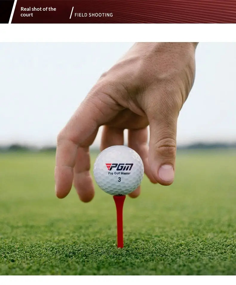 White PGM Pro Golf Master 3 ball on red tee