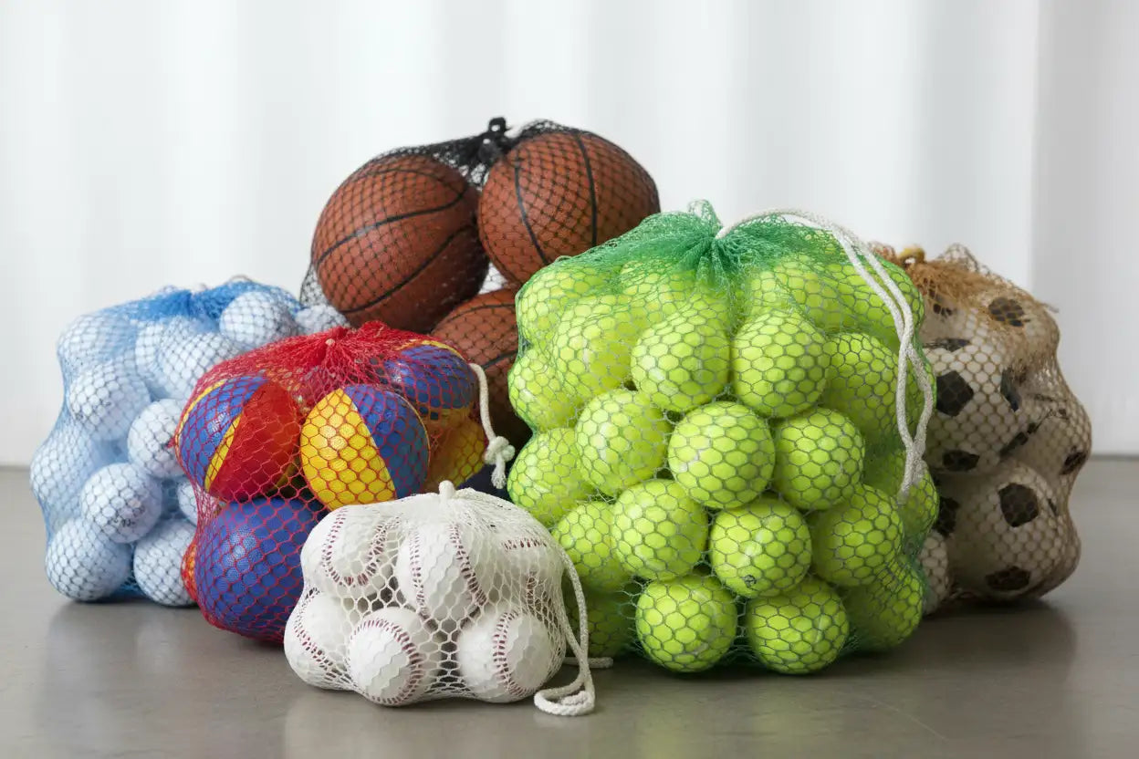 A vibrant green mesh bag filled with bright neon yellow tennis balls.